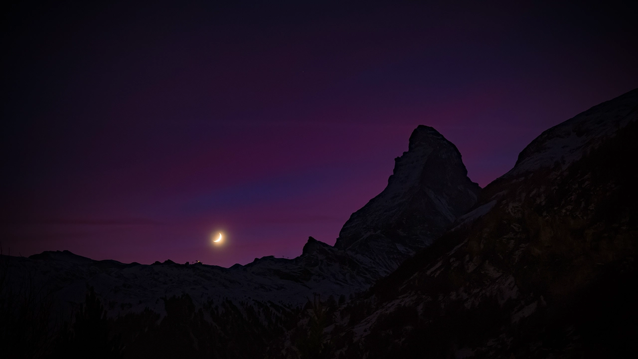 Night view of the Matterhorn with a thin moon